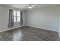 Cozy bedroom with natural light, wood flooring and neutral tones at 506 Hogwart Ln., Longs, SC 29568