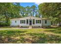 A cozy single-story home boasts a manicured lawn and classic black shutters, enhancing its curb appeal at 5074 Cowart Ct., Murrells Inlet, SC 29576