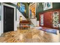 Elegant foyer with staircase, piano, high ceilings, and striking marble tile flooring at 58 Swan Point Trail, Georgetown, SC 29440