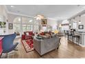 Spacious living room featuring hardwood floors, a fireplace, and large windows offering great natural light at 6434 Longwood Dr., Murrells Inlet, SC 29576