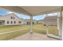 Cozy screened-in porch overlooking a spacious backyard and neighboring houses at 701 Rupert Dr, Conway, SC 29526