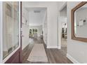 Bright entryway with hardwood floors, leading to an open living area and dining space at 725 Doonbeg Ct., Conway, SC 29526