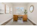 Stylish home office with decorative rug, wood desk, interior decor, and bright natural light at 729 Doonbeg Ct., Conway, SC 29526