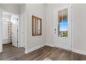 Entryway features wood-look floors, a half-glass door, and a stylish mirror at 733 Doonbeg Ct., Conway, SC 29526