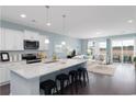 Open-concept kitchen with island, white cabinets, and stainless steel appliances at 741 Doonbeg Ct., Conway, SC 29526