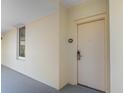 Exterior shot of a unit showing the entrance door with view along a walkway at 8121 Amalfi Pl. # 4-1006, Myrtle Beach, SC 29572