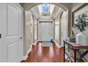 Grand foyer with hardwood floors, arched doorways, and decorative glass accents, showcasing elegance at 904 Moultrie Circle, Myrtle Beach, SC 29588