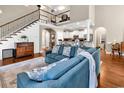 Spacious living room with hardwood floors, soaring ceilings, and staircase with decorative iron railing at 904 Moultrie Circle, Myrtle Beach, SC 29588