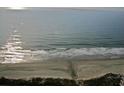 Serene beach view with gentle waves and 'I heart KAT' written in the sand at 9994 Beach Club Dr. # 2402, Myrtle Beach, SC 29572