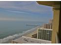 Beautiful ocean view from a high-rise balcony with waves and distant pier at 9994 Beach Club Dr. # 2402, Myrtle Beach, SC 29572