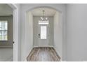 Bright entryway with hardwood floors, arched doorway, and a modern chandelier at 1092 Laconic Dr., Myrtle Beach, SC 29588
