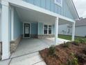 Covered porch area featuring brick detail at the base and square white support beams at 1117 Oxeye St., North Myrtle Beach, SC 29582