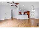Bright living room with hardwood floors, high ceiling with fan, open to the kitchen area at 1636 Stuart Square Circle, Myrtle Beach, SC 29577