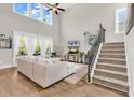 Open-concept living room featuring high ceilings, large windows, and staircase with iron railing at 1662 Westminster Dr., Myrtle Beach, SC 29577