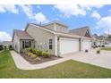 A cozy home with a manicured lawn, featuring a two-car garage and attractive landscaping at 1807 Berkley Village Loop, Myrtle Beach, SC 29579