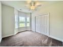 A bedroom includes a large window with closet and ceiling fan at 181 Norris Ln, Loris, SC 29569