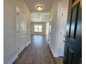 Welcoming entryway featuring wood-look flooring, neutral walls, and a view of the open living space at 181 Norris Ln, Loris, SC 29569