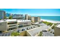 Beach view of the condo community showing nearby hotel, parking and ocean at 201 74Th Ave. N # 707, Myrtle Beach, SC 29572