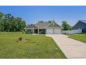 Well-maintained single-story home with a lush green lawn and an extended driveway at 2080 Highway 915, Loris, SC 29569
