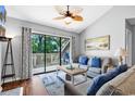 Comfortable living room boasts stylish furnishings, a relaxing atmosphere, and seamless access to the outdoor deck at 213 Westleton Dr. # 16-D, Myrtle Beach, SC 29572