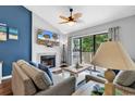 Inviting living room with a cozy fireplace, plush seating, and a sliding glass door to a private deck at 213 Westleton Dr. # 16-D, Myrtle Beach, SC 29572