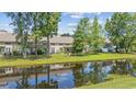 Back of condo overlooking a well maintained yard and a tranquil pond at 2150 Longwood Lakes Dr. # 2150, Myrtle Beach, SC 29579