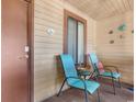 Cozy porch with two chairs, a small table, and decorative coastal accents at 223 Maison Dr. # 14D, Myrtle Beach, SC 29572