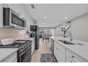 Bright kitchen featuring stainless steel appliances, white cabinetry, and open layout to the dining area at 2352 Elowen Ln. # 22B, Longs, SC 29568