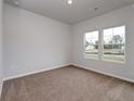 Cozy bedroom with two windows and neutral carpet flooring at 262 Dunlin Pl, Conway, SC 29526