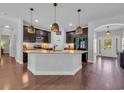 Modern kitchen with granite countertops, stainless steel appliances, and dark wood cabinets at 321 Sanctuary Ct., Myrtle Beach, SC 29588