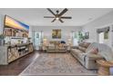 Bright living room with a large flat screen TV, ceiling fan, and comfortable seating at 321 Sanctuary Ct., Myrtle Beach, SC 29588