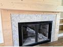 Close up of a fireplace with a unique, decorative herringbone tile surround at 3619 Allentown Dr., Conway, SC 29526