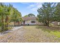 Inviting home with front yard, walkway and mature trees under a bright sky at 415 42Nd Ave. N, Myrtle Beach, SC 29577
