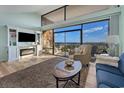 Inviting living room with fireplace and ocean views from large windows and a sliding glass door at 423 Parker Dr. # 613, Pawleys Island, SC 29585
