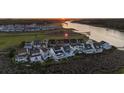 Aerial view showcases a row of waterfront houses with marsh views and a serene river at sunset at 4525 Landing Rd., Little River, SC 29566