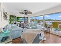 Bright living room with light blue sofas, hardwood floors, large windows, and views of the marina at 4534 Landing Rd., Little River, SC 29566