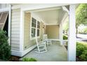 Cozy covered porch with classic rocking chairs, offering a charming and relaxing outdoor space at 4901 N Market St., North Myrtle Beach, SC 29582
