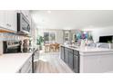 Modern kitchen with stainless appliances, center island, and open to the dining area at 506 Haven View Way, Murrells Inlet, SC 29576