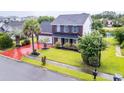 Aerial view of home featuring a well-kept lawn, mature trees and landscaping on a corner lot at 5096 Capulet Circle, Myrtle Beach, SC 29588