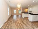 Open living space with wood-look floors that connects to a kitchen at 5096 Capulet Circle, Myrtle Beach, SC 29588