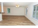 Bright living room with wood-look floors, large windows, and fresh paint at 5096 Capulet Circle, Myrtle Beach, SC 29588
