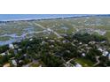 Breathtaking aerial view showcasing waterfront property with surrounding marshland and nearby beaches at 514 Blockade Dr., Pawleys Island, SC 29585