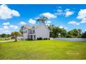 Well-maintained home with a spacious yard, featuring a classic design and lush green surroundings at 547 Pacific Commons Dr., Surfside Beach, SC 29575