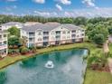 Aerial view of condo overlooking a serene pond with a fountain feature at 5825 Catalina Dr. # 125, North Myrtle Beach, SC 29582