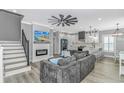 Open living area with a fireplace, TV, ceiling fan, and modern kitchen with white cabinetry at 6001- Q10 S Kings Hwy., Myrtle Beach, SC 29575
