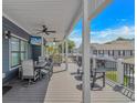 Spacious covered porch with ceiling fans, TV, and outdoor seating, perfect for entertaining at 6001- Q10 S Kings Hwy., Myrtle Beach, SC 29575