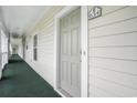 Condo entrance featuring green carpet, neutral walls, and clear unit number signage at 6015 Catalina Dr. # 634, North Myrtle Beach, SC 29582