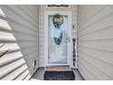Close up of the front door with decorative glass and a welcoming wreath at 605 Fieldwoods Dr., Conway, SC 29526
