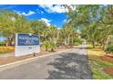 Sign for Sandpiper Run Building B at 741 in a scenic setting with mature trees at 741 Retreat Beach Circle # B-1-A, Pawleys Island, SC 29585