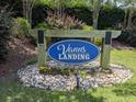 Community entrance sign for Vanns Landing, nestled amongst flowers and greenery at 748 Old Murrells Inlet Rd., Murrells Inlet, SC 29576